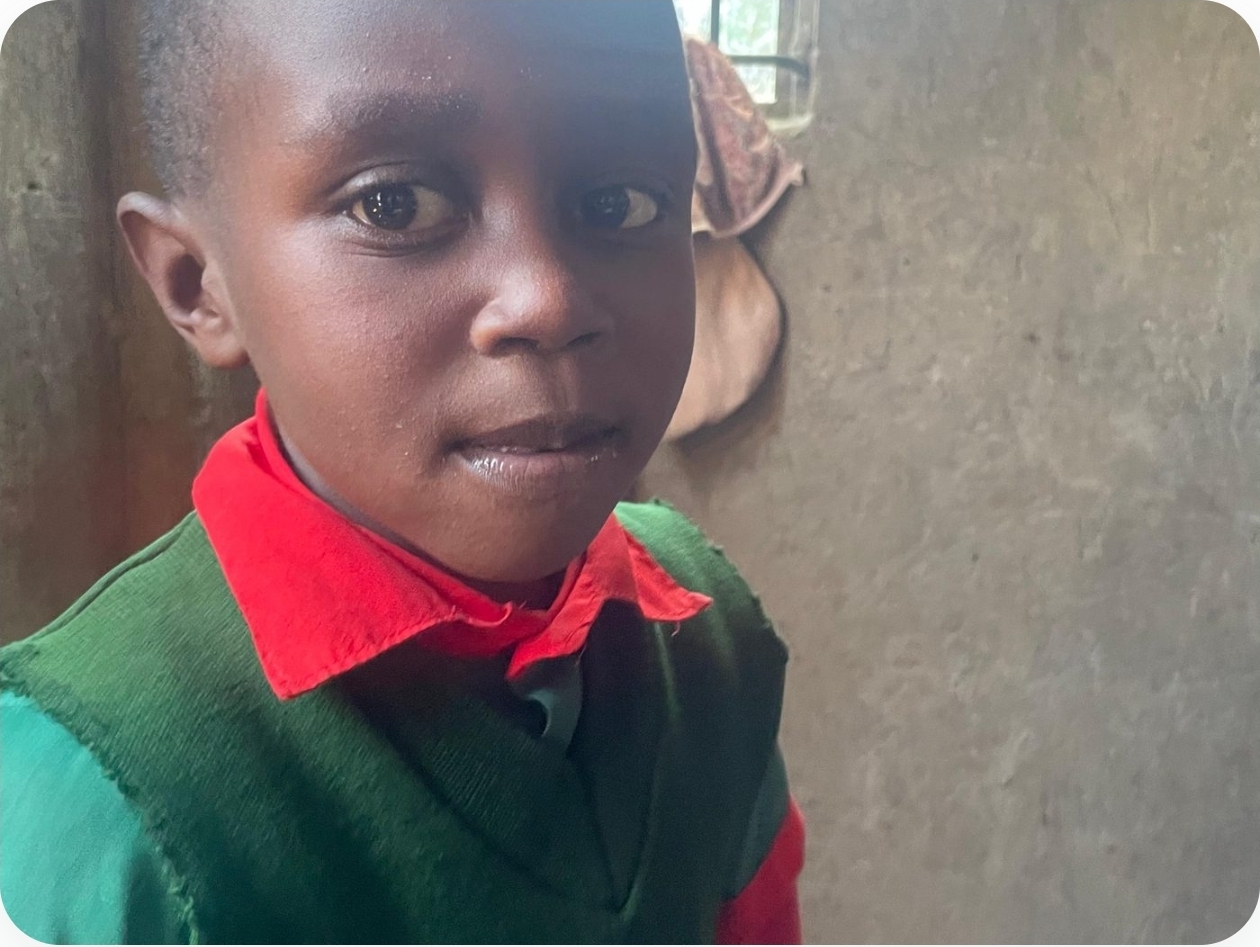 A student in a green and red school uniform at the center